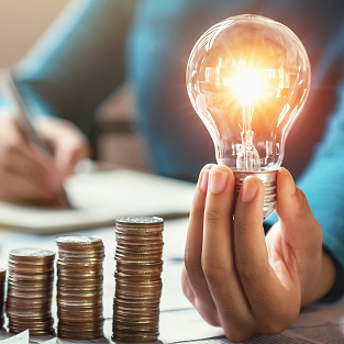 business woman hand holding lightbulb with coins s 2025 05 19 00 29 05 utc